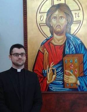 Deacon Andrew with an icon of Our Lord as Teacher.